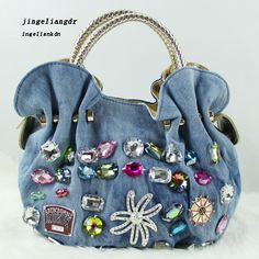 a blue purse with lots of jewels on it