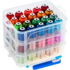 a plastic container filled with lots of spools of thread