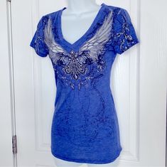 Nwot Embellished Blue Rhinestone Shirt. Wing Design Is See-Through. Fitted Blue Tops With Rhinestones, Fitted V-neck Top With Rhinestones, Embellished Blue V-neck Top, Blue Embellished V-neck Top, Blue Embellished Short Sleeve Top, Blue Embellished Top With Short Sleeves, Rhinestone Shirt, Rhinestone Shirts, Wing Design