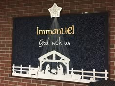 a christmas nativity scene with the birth of jesus and baby jesus, hanging on a brick wall