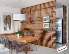 an image of a dining room with wood slats on the wall and chairs around the table