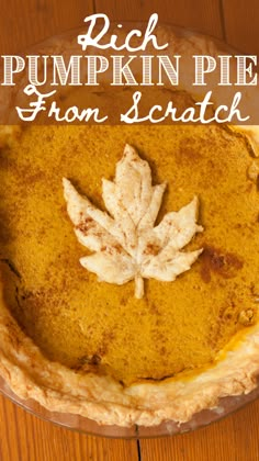 a pumpkin pie with a maple leaf on top and the words, rich pumpkin pie from scratch