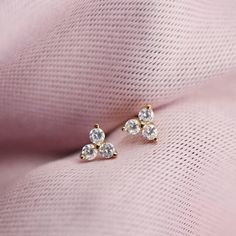 Our gold three stone crystal studs are packed with tons of sparkle. Perfect for a first, second or third piercing. Wear them solo or stack them up with your other favorite studs and hoops for a cool, curated ear look. DETAILS - Cubic zirconia crystals - 4.5mm across - Matching earring backs included - Gold plated over sterling silver Also available in sterling silver, see it here: https://etsy.me/3ufXUSw Shown here with our Elongated Huggies: https://etsy.me/3AJxk5r And Lightning Bolt Studs: htt Gold Three Stone Earrings For Anniversary, Gold Three-stone Earrings For Gift, Third Piercing, Diamond Earrings Indian, Piercing Inspiration, Deer Jewelry, Curated Ear, Stone Stud Earrings, Earrings Indian