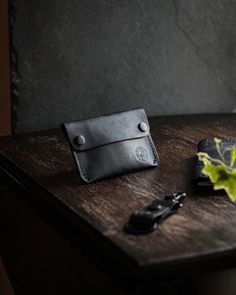 The Kite Pocket wallet in Limited Drop Black Maya. Handcrafted in Britain.  The Kite is handcrafted, hand stitched, hand burnished minimalist Pocket wallet, made from Conceria Il Pontes Tanneries famous Maya leather in Black. In time patina will tell this wallets story as well as yours, a companion for life.  Comfortably holds 4 cards and cash . Limited Edition drop for July 2021. Specs:  - Top grain Vegetable Tanned leather  - Individually Hand crafted and Handstiched - Holds 4 cards plus, and Hand-stitched Leather Card Holder For Everyday Use, Artisan Card Holder For Everyday Use, Black Leather Wallet Hand-stitched, Hand-stitched Black Leather Wallet, Handmade Black Leather Coin Purse, Black Leather Handmade Coin Purse, Minimalist Leather Coin Purse, Minimalist Leather Bifold Coin Purse, Handmade Leather Wallets For Everyday Carry