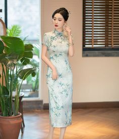 Indulge in the exquisite elegance of this green Cheongsam dress. Featuring a delicate bamboo leaves print and a traditional mandarin collar, this dress is adorned with two subtle side slits, creating a timeless and sophisticated silhouette, perfect for any special occasion. Size Guide: Please refer to the size guide picture before placing the order. Please leave your Height, Weight Bust, Waist and Hip measurements in the Personalisation box so we could double check the size for you. Traditional Fitted Floral Print Cheongsam, Traditional Fitted Floral Cheongsam, Green Fitted Long Ao Dai, Fitted Long Green Ao Dai, Green Qipao, Green Cheongsam, Traditional Chinese Fashion, Chinese Green, Green Bamboo