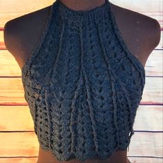 a mannequin wearing a gray crocheted halter top