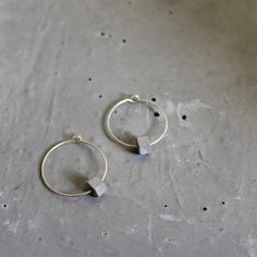 "Small hoop earrings, handmade of sterling silver with concrete beads. Minimalist and elegant, modern jewelry for women. Unique and minimalist, hoop earrings for everyday wear. These urban earrings are part of BAARA Jewelry's concrete jewelry collection. This collection is inspired by our love of the city landscape and architecture. Each sterling silver hoop has a hexagon bead threaded on it. The beads are handmade of concrete, they are cast, filed, and finished by hand. These everyday earrings Gray Minimalist Jewelry For Everyday, Minimalist Gray Jewelry For Everyday, Gray Minimalist Jewelry For Everyday Wear, Minimalist Gray Sterling Silver Jewelry, Architecture Jewelry, Concrete Necklace, Small Silver Hoop Earrings, Earrings Small Hoop, Dramatic Earrings