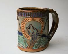 a ceramic mug with an image of a wolf on the front and side, sitting on a white surface