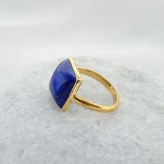 Lapis Lazuli Ring, Beautiful Lapis Lazuli 12x12mm Square Shape Gemstone Ring, 18k Gold Plated Bezel Ring, 925 Silver Lapis Rings for Women Item Code: BTJW2049 Metal: 925 Sterling Silver Plating: 18k Gold Plated Stone Detail :Lapis Lazuli, Square, 12mm x 12mm * Please note that there will be slight variations in stone texture and color shades in the actual product that you receive. Stone quality or grade will be same. * All our jewelry is Micron Plated which is higher quality as compared to Stand Lapis Lazuli Gemstone Rings As Gift, Lapis Lazuli Gemstone Ring For Gift, Classic Lapis Lazuli Ring As Gift, Fine Jewelry Lapis Lazuli Rings For Gifts, Classic Lapis Lazuli Ring As A Gift, Gold Lapis Lazuli Ring As Gift, Gold Lapis Lazuli Ring For Gift, Elegant Lapis Lazuli Ring As Gift, Elegant Adjustable Lapis Lazuli Ring