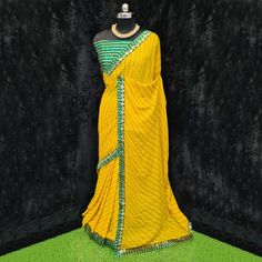 Product Detail - yellow colored casual wear saree is made from moss georgette fabric which is highlighted with beautiful stripes printed work with lace border as shown. Comes along unstitched heavy gota blouse piece which you can customise as per your design/style. Occasion - You can wear this saree for casual, outings, social meets and other homely events. Style it up - Look glamorous in this traditional saree by (HELUM FAB) Pair this saree with beautiful clutch to complete the look!! Measureme Fitted Yellow Georgette Saree, Yellow Semi-stitched Georgette Pre-draped Saree, Saree With Lace Border, Luxury Yellow Saree With Printed Border, Yellow Saree With Black Border, Yellow Saree With Printed Border, Traditional Saree, Georgette Saree, Wear Saree