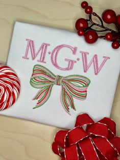 a candy cane, lollipops and an embroidered monogram on a piece of paper