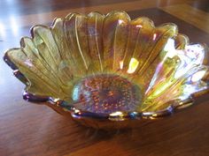 a glass bowl sitting on top of a wooden table