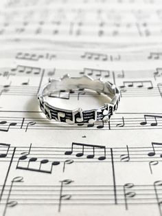 This classic ring is an encircled band of music notes. Wear alone or stack with one of our many rings! Sterling silver. Available in whole sizes 5-10. 1/8" (4mm) wide. Many Rings, Rings Sterling Silver, Music Note, Classic Ring, Ring Sterling Silver, Music Notes, Teacher Gifts, Silver Rings, Wedding Rings