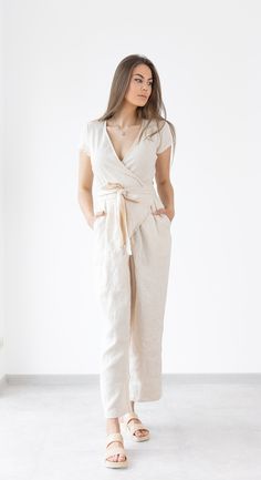 Wrap linen jumpsuit Mila  - relaxed fit linen soft linen jumpsuit / beach jumpsuit. Summer clothing created by MinimalisticLinen DETAILS ----------------- * short sleeves * Wrap jumpsuit * Pockets * Belt * Made from OEKO - TEX Standard 100 certified European linen fabric which guarantees you that it meets human - ecological requirements. * Handmade item. Cut and sewn by professionals in our family studio.  FIT ----------------- * Relaxed fit IMAGES ----------------- * Model is wearing XS/S * Please note that colors can slightly mismatch from pictures due to factors that are beyond our control like your display settings, device you are using etc. CARE INSTRUCTIONS ----------------- * Machine wash in cold water up to 30ºC/86ºF gentle cycle * Dry on low heat or hang to dry for best results. * Beige Linen Jumpsuits And Rompers For Loungewear, Beige Linen Overall Jumpsuits And Rompers, Beige Linen Casual Jumpsuits And Rompers, Beige Linen Overalls Jumpsuit, Chic Beige Linen Jumpsuits And Rompers, Beige Linen Overalls, Spring Fitted Linen Jumpsuits And Rompers, Fitted Linen Jumpsuits And Rompers For Spring, Chic Linen Jumpsuits And Rompers With Short Sleeves