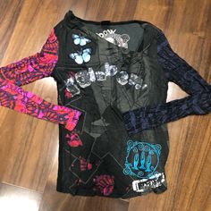 Nwot Desigual Embroidered Long Sleeve T-Shirt. Size Small. Has An Uneven Neck Collar. In Perfect Condition. Bundle To Save. Trendy Long Sleeve T-shirt With Embroidered Graphics, Black Long Sleeve T-shirt With Embroidered Graphics, Alternative Crew Neck Tops For Fall, Alternative Style Crew Neck Tops For Fall, Fitted Graffiti Print Crew Neck Top, Fitted Crew Neck Top With Graffiti Print, Alternative Long Sleeve Spring T-shirt, Punk Style Printed Cotton Tops, Spring Punk Cotton Tops