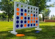 an outdoor game set up in the grass with orange and blue circles on it's sides