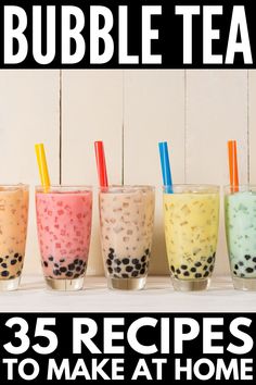 five bubble teas with strawberries and blueberries in them