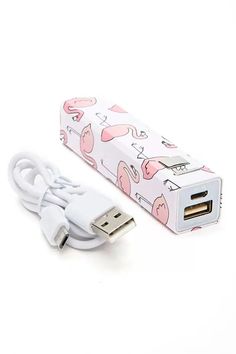 a white and pink power strip sitting on top of a white table next to a charger