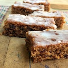 several pieces of cake sitting on top of a wooden cutting board