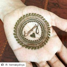 a person's hand holding a hendi with the word mommy written in it