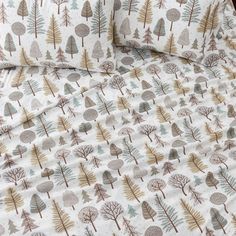 an image of a bed set with trees on the sheets and pillow cases in brown