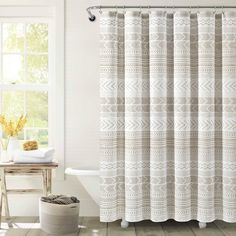 a bathroom with a white tub and shower curtain