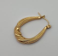 Single 14K Oval Hoop Tube with Twist Yellow Gold Post Earring Vintage Karat KT Solid Pierced (only 1 earring) Materials: 14K solid gold metal marked - 585 = 14K Condition: very good vintage & are hollow - with one ding that I see (in last image close-up) Weight in grams - .69 Measures - 1 x 3/4 x  1/8 inches Maker's mark - ZZ with a mark but I cannot make it out Questions welcome. Oval 14k Gold Tarnish-resistant Hoop Earrings, Oval 14k Gold Tarnish Resistant Hoop Earrings, 14k Gold Oval Hoop Earrings Tarnish Resistant, Yellow Gold Oval Hoop Earrings With Ear Wire, Classic Gold Plated Oval Hoop Earrings, Classic Oval Gold-plated Hoop Earrings, Classic Oval Gold Plated Hoop Earrings, Gold Oval Tarnish Resistant Hoop Earrings, Gold Oval Hoop Earrings Tarnish Resistant