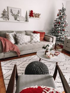 a living room filled with furniture and a christmas tree