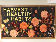 a bulletin board with leaves and writing on it that says harvest healthy habitts,