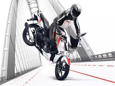 a person on a motorcycle jumping over a bridge with red and white lines in the background