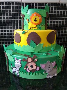 a three tiered cake with animals on it