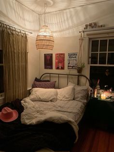 a bed sitting in a bedroom next to a window