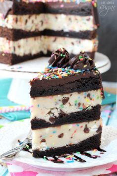 a slice of ice cream cake with chocolate frosting and sprinkles