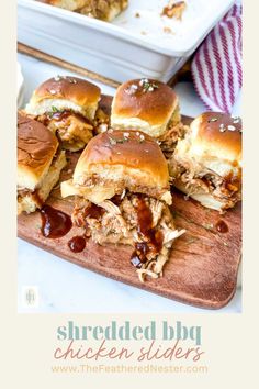 shredded bbq chicken sliders on a cutting board