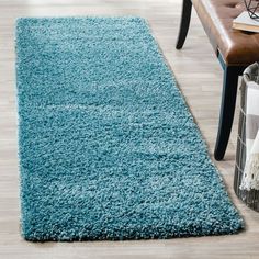 a blue rug on the floor in a living room