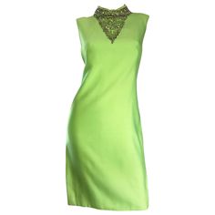 Chic vintage 1960s lime green shift dress! Flattering shilouette, with amazing details! Features hand-sewn iridescent sequins and beads at bust, with pearls lining the collar. Jackie O style that exudes class and fashion! Designer labels are missing, but most certainly produced by a high-end designer by the amazing construction. Full metal zipper up the back with hook-and-eye closure. No fabric label, but feels like a possible silk and cotton blend. In great condition. Approximately Size Medium 1stdibs Fashion, Suit Tattoo, Bright Green Dress, Green Chiffon Dress, Vintage Green Dress, Green Sequin Dress, Informal Dress, Lime Green Dress, Green Shift Dress