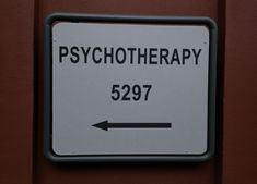 a sign that is on the side of a building saying, psychic therapy 5297