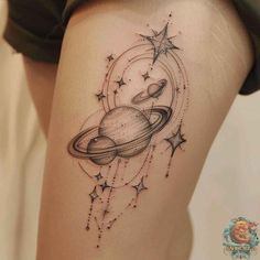 a woman's thigh with an image of saturn and stars in the sky on it