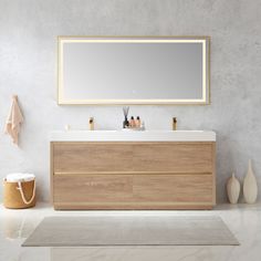 a bathroom vanity with a large mirror above it and two vases on the floor