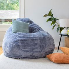 a blue bean bag chair sitting on top of a white rug