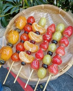 fruit skewers are displayed on a plate