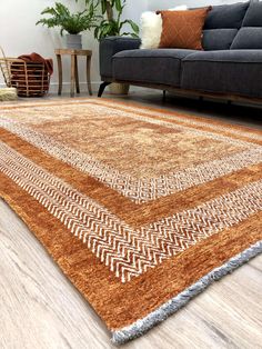 a living room area with a couch, chair and rug