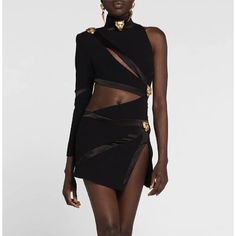 a model in a black dress with gold accents