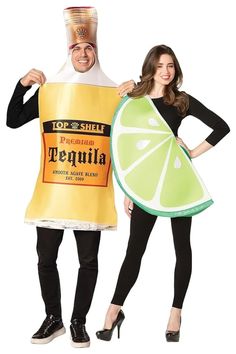 two people dressed in costumes standing next to each other and one is holding a slice of lemon