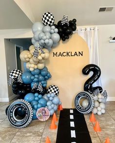 an entrance to a race themed party with balloons