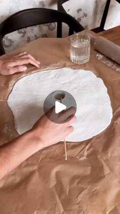 someone is making something out of paper on the table