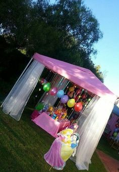 there is a pink and white tent with balloons on it