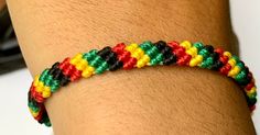 a person wearing a colorful bracelet on their arm