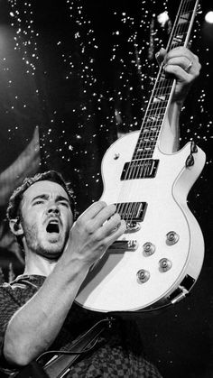 black and white photograph of a man playing an electric guitar