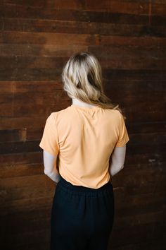 Feel the summer vibes with Jessa In Marigold! This cheerful and lightweight orange top features a flattering ribbed texture, short sleeves, and a fitted style for a perfect fit. Stay stylish and comfortable all day long in this must-have piece. This top is paired with the Marigold Maxi Skirt. Fits true to size. Model is wearing a small and is 5'3". Plus model is wearing an XL and is 5'7". The color in the pic shown with the Marigold Maxi Skirt is more color accurate. Size Chart Length Bust S 21. Stretch T-shirt For Day Out, Casual Fitted T-shirt For Loungewear, Sporty Short Sleeve Top For Spring, Fitted Short Sleeve Top With Ribbed Neckline For Summer, Casual Fitted Short Sleeve Top With Ribbed Neckline, Sporty Short Sleeve Top For Summer Everyday Wear, Basic Orange Tops For Summer, Spring Basic Short Sleeve Top With Ribbed Neckline, Spring Short Sleeve Tops With Ribbed Neckline